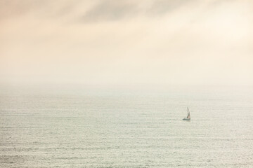 Lonely sailing ship at sea, concept of loneliness, achieving goals, dreams.
