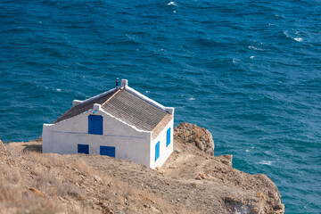 House on the edge of a cliff overlooking the sea
