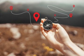 Traveler hand holds a compass on the beautiful Carpathian mountains view in a sun. Horizontal...
