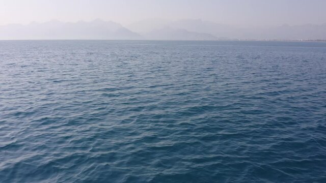 Beautiful seascape and mountain view on the horizon. Picturesque marine background.
