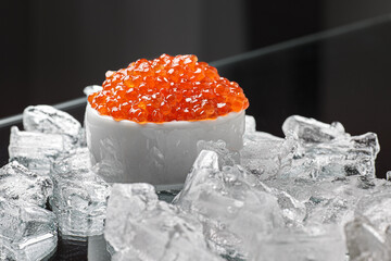 Red caviar in a bowl. Christmas and New Year background