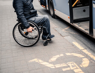 Person with a physical disability enters public transport with an accessible ramp.