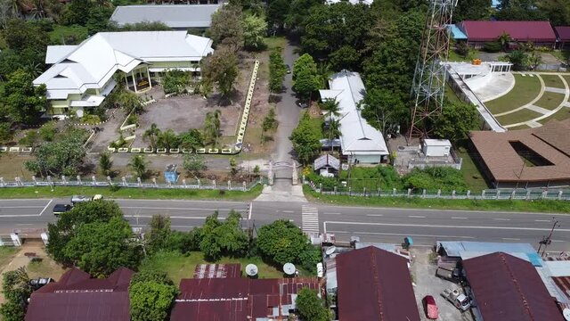 Manokwari, West Papua, Indonesia - August 21, 2020: in front of the gate aerial view of the university of Papua (UNIPA) with a drone, slow motion shooting.