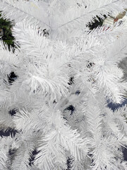 branches of artificial white christmas tree, close-up