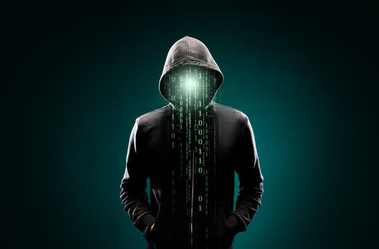 Computer hacker in hoodie. Obscured dark face. Data thief, internet fraud, darknet and cyber security concept.