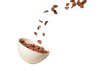 Chocolate corn flakes falling to the white bowl isolated on white. Motion.