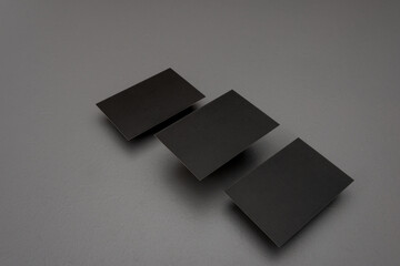  three Black mock up business card for branding on grey rustic background .
