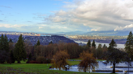 Obraz premium Car park shortly after rain at Burnaby Mountain Park with view down Burrard Inlet downtown Vancouver, Stanley Park and Stratis of Georgia.