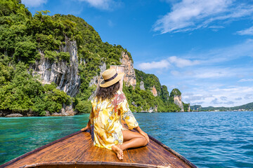 Koh Phi Phi Thailand, Asian woman in longtail boat exploring the Phi Phi Lagoon around the Island. 