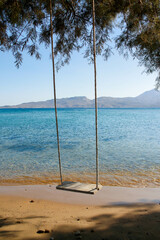 paradisiacal swing on turquoise beach in the island of milos