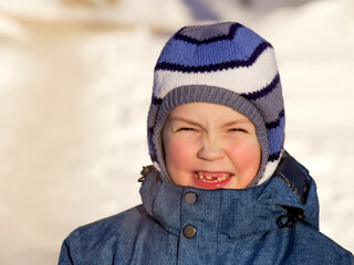 Funny portrait of a boy in winter clothes
