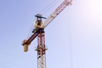 Tower crane on a blue sky background