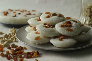 Vattappam in Idly shape. Steamed rice cake made of sweet fermented batter of rice and coconut, topped with raisins steamed using Idly mould.