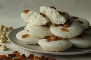 Vattappam in Idly shape. Steamed rice cake made of sweet fermented batter of rice and coconut, topped with raisins steamed using Idly mould.