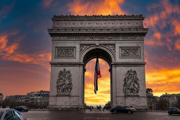 Champs-Elysees and Arc de Triomphe at sunset in Paris, France. Architecture and landmarks of Paris. Postcard of Paris during epic sunset.
