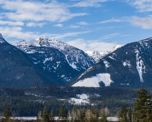 panorama of high mountains covered by snow cloudy blue sky british columbia canada