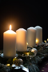Fourth advent, four candles - candlelight on dark brown panorama background - advent banner. Horizontal banner for homepage. Template for greeting cards, funeral cards and obituaries.