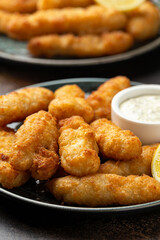 Crispy Fish strips with tartar sauce in a plate