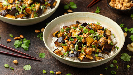 Asian Eggplant with rice, peanuts and spring onion. Healthy food.