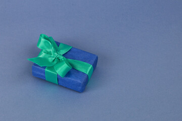 Dark blue gift box on a light blue background.