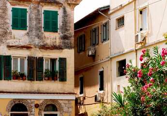 Fototapeta na wymiar Old European Mediterranean town cityscape, windows with old green wooden shutters, ropes for laundry, mediterranean, italian, venetian streets