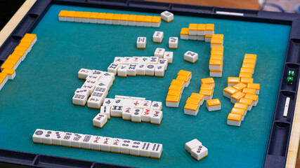 Many Mahjong tiles on on the playing field. An ancient asian game called Mahjong as a way to spend your free time with joy and get some fun. Mahjong table.