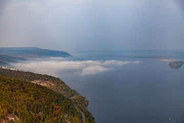 Zhigulevskie mountains in autumn and a view of the Volga with clouds above it in autumn. Aerial photography. Samara, Russia.