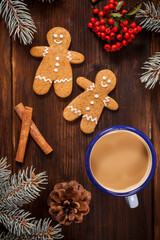 Gingerbread man cookies an coffee cup by vertical angle. - 474554858