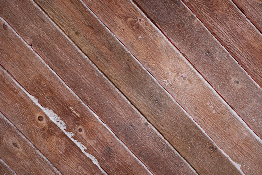 background of brown boards at an angle of 45 degrees covered with frost