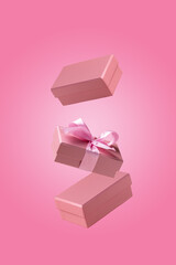 three craft gift boxes fly on pink background