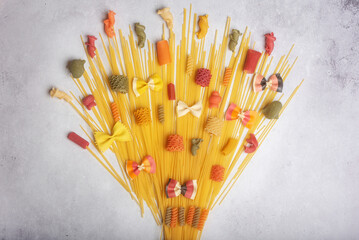 A different decorative bouquet of different types of spaghetti on colorful backgrounds. Food Concept