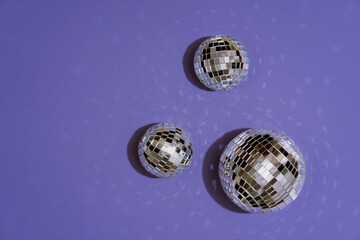 Beautiful shiny Christmas balls on violet trendy background. New Years celebration concept.