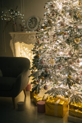 A lighted Christmas tree with presents underneath in living room