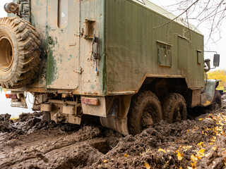 Fototapeta premium The truck got stuck on a dirty, broken forest road. Autumn thaw. Off - road