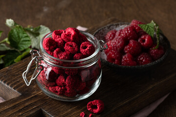 freeze-dried raspberries in a glass jar on wooden background