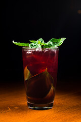 Fresh homemade cherry lemonade on dark bar background. Summer refreshment drink close up.