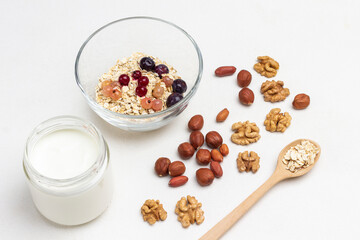 Nuts, oatmeal in wooden spoon.