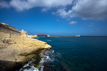 The gateway to the waters of Valletta. Lighthouse. Coast of the island of Malta.