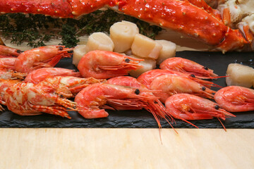 scallops, shrimp, crab legs on a dark background