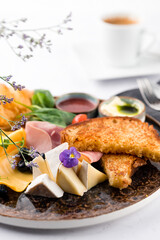 french breakfast of croissant, brioche bread, cheese and ham with butter on a plate