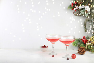 Christmas alcoholic cocktail with cranberry and cinnamon spice, red mimosa cocktail with champagne, warming winter drink in the cold season, christmas festive grog, winter composition, selective focus
