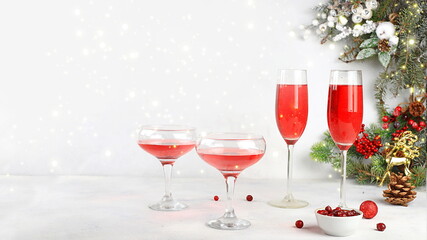 Christmas alcoholic or non-alcoholic cocktail with cranberry and cinnamon spice, red mimosa...