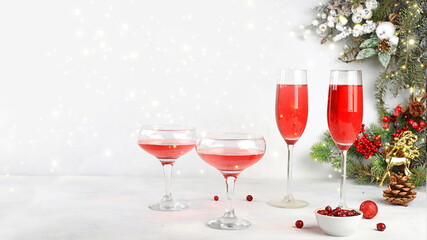 Christmas alcoholic or non-alcoholic cocktail with cranberry and cinnamon spice, red mimosa cocktail with champagne, warming winter drink in the cold season, christmas festive grog,