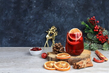 Christmas alcoholic or non-alcoholic cocktail with cranberry and cinnamon spice warming winter drink in the cold season, christmas festive grog, winter composition,