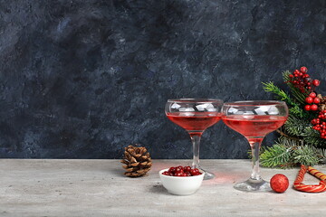 Christmas alcoholic or non-alcoholic cocktail with cranberry and cinnamon spice, red mimosa cocktail with champagne, warming winter drink in the cold season, christmas festive grog,