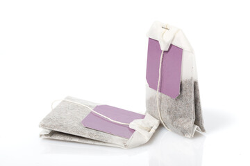 Tea bags with colored labels. Isolated over white background. Close-up.