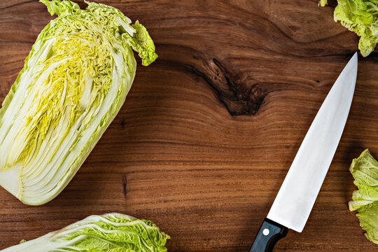 Chinese Cabbage Salad. Ripe Head Of Cabbage On A Cutting Board Next To The Chef's Knife, Cooking Dinner. View From Above