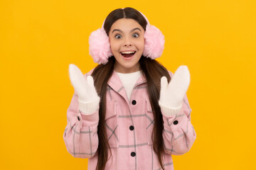 amazed teen girl in mittens. portrait of child wearing warm clothes.