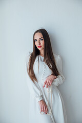 beautiful woman in a light summer dress on a white background