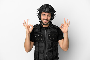 Young caucasian swat isolated on white background showing an ok sign with fingers